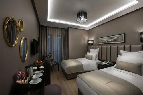 Ένα ή περισσότερα κρεβάτια σε δωμάτιο στο Le Petit Palace Hotel - Special Category