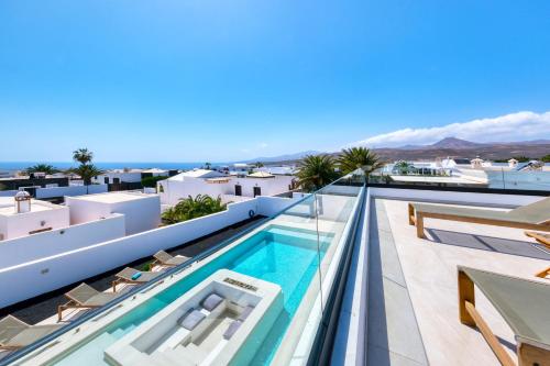 a swimming pool on the roof of a house at White House - Fire pit and Private pool By Lanzarote Vacation Homes in Puerto Calero