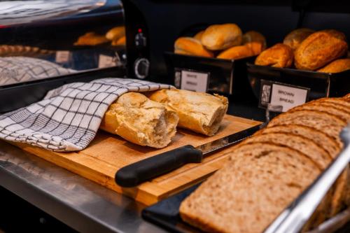 a display of bread and breadsticks on a table at Onyx Hotel in St Julian's