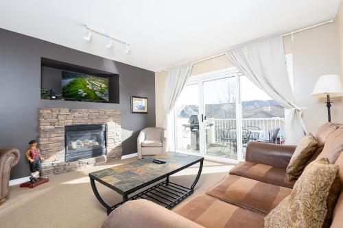 a living room with a couch and a fireplace at Paradise Canyon Golf Resort - Luxury Villa 409 in Lethbridge