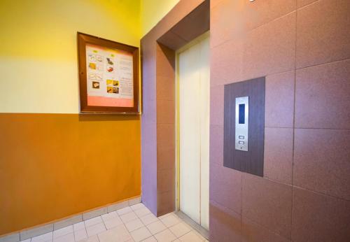 a hallway with a sign on the wall of a restroom at Sun Inns Hotel Sunway Mentari in Petaling Jaya