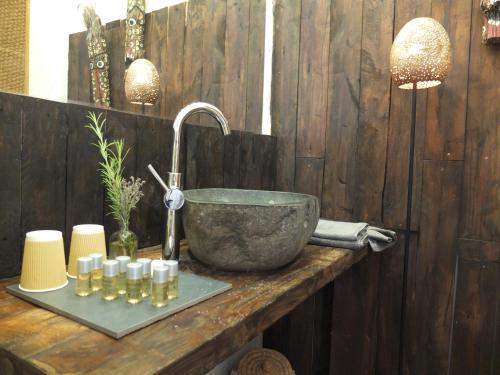 a bathroom with a bowl sink and candles on a counter at Peralta Villas Boutique Adults Only in Renau