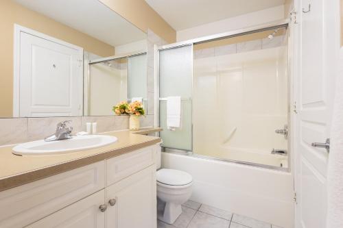 a bathroom with a sink and a toilet and a shower at Paradise Canyon Golf Resort - Luxury Condo M407 in Lethbridge