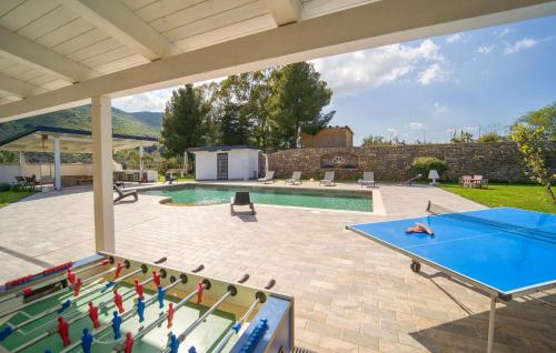 an outdoor pool with a ping pong table and a ping pong table at Dimora Di Famiglia in Belmonte Mezzagno