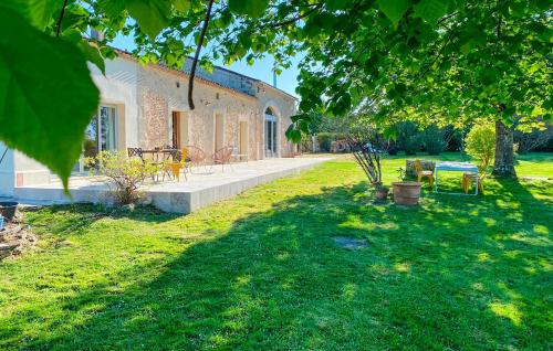 a house with a garden and a yard with green grass at Nice Home In Saint-Géraud-De-Corps in Saint-Géraud-de-Corps
