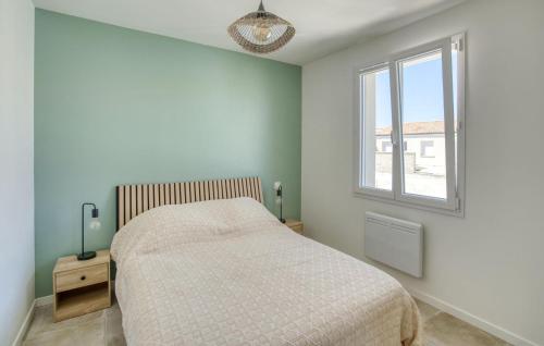 a bedroom with a bed and a window at Nice Home In Semussac in Sémussac