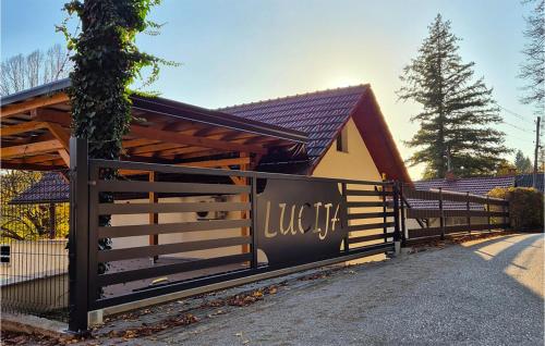 a house with a wooden fence in front of it at Awesome Home In Ozalj With Kitchen in Ozalj