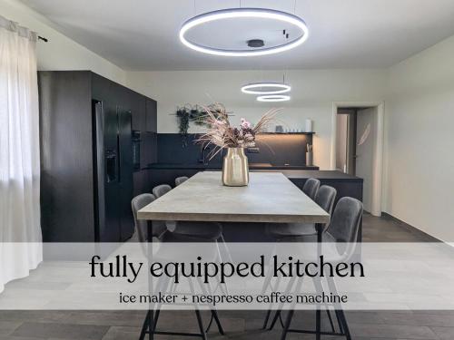 a dining room with a table with a vase of flowers at Spacious villa with pool, indoor jacuzzi and sauna near Poreč in Višnjan