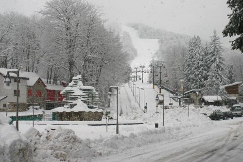 a street covered in snow with a ski slope at Hotel Centrale in Gambarie dʼAspromonte