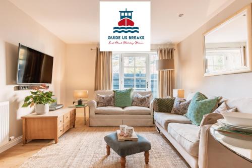 a living room with a couch and a tv at St Leonard's Luxury Lodge, St Andrews in St. Andrews