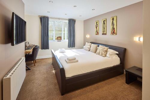 a bedroom with a bed and a desk in it at Aaron Accommodation in Whitby