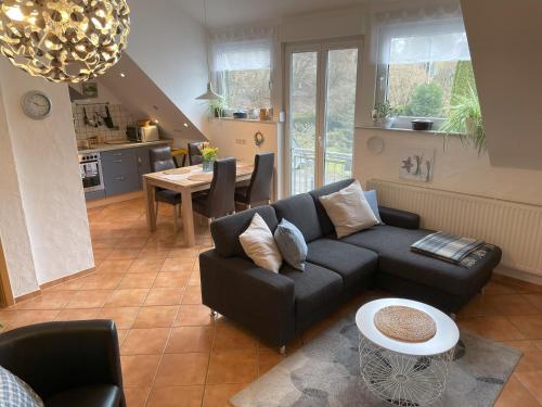 a living room with a couch and a table at Ferienwohnungen Grafenfelder Hof in Gerolstein