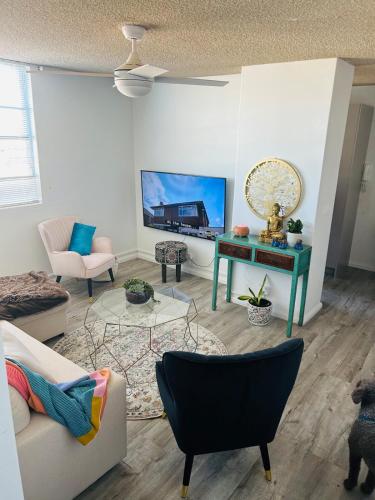 a living room with a couch and a table at Chic Retreat in Granville - steps to train ! in Clyde