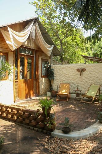 a small house with two chairs and a patio at Monsoon Eco Resort - Whisky point Arugambay in Pottuvil