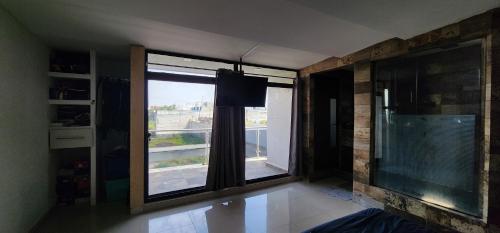a room with a large window with a view at Casa BAS in Xochitenco