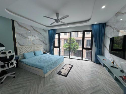 a bedroom with a bed and a large window at Luxury homestay in Vinhomes Oceanpark 3 3 large bedrooms with wet sauna cabin in Cửu Cảo