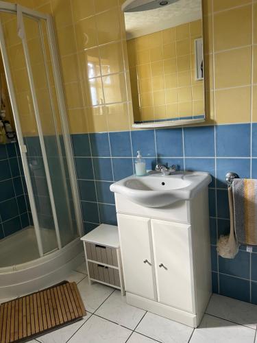 a bathroom with a sink and a shower at The Bungalow by SJP Kettering in Kettering