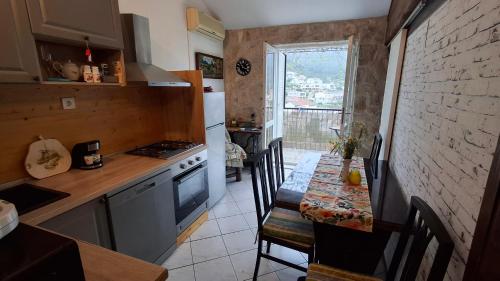 a kitchen with a table and a kitchen with a stove and refrigerator at Stunning view-Maleni in Vis