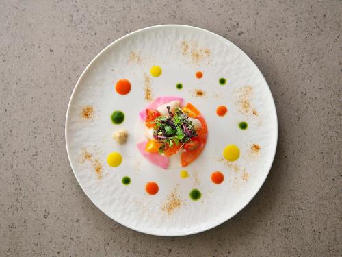 a white plate topped with food on a table at SAPPORO HOTEL by GRANBELL in Sapporo