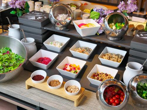 a buffet filled with bowls of different types of food at SAPPORO HOTEL by GRANBELL in Sapporo