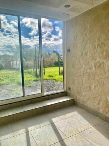 a window in a room with a view of a field at Le nid voûté in Libin