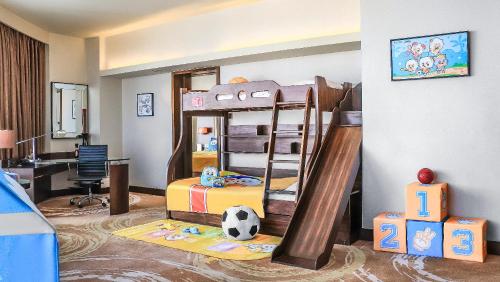 a bedroom with a bunk bed with a soccer ball on the floor at Crowne Plaza Kunming City Centre by IHG in Kunming