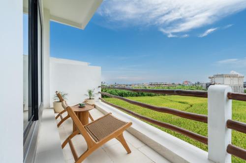 a balcony with a table and chairs and a view at Villa Le Blanc - Tropical Luxury 3BR Villa with Pool & Rooftop Views in Tumbak Bayuh in Tumbak Bayuh