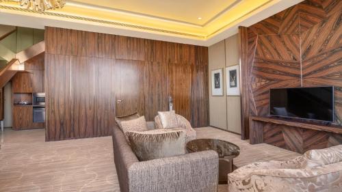 a living room with a couch and a tv at Crowne Plaza Kunming City Centre by IHG in Kunming