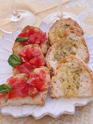 a plate of toast with tomatoes on it at Hotel Minerva in Siena