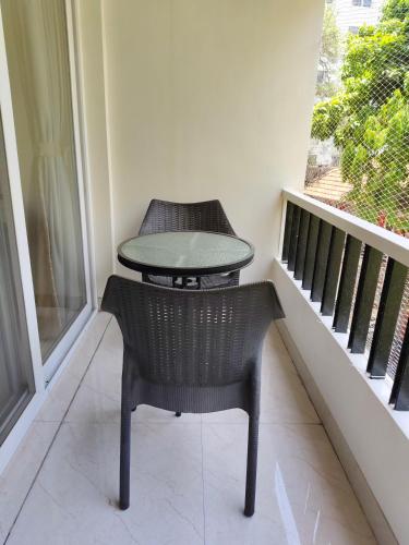 a table and chair sitting on a balcony at Hotel Shreyas in Pune