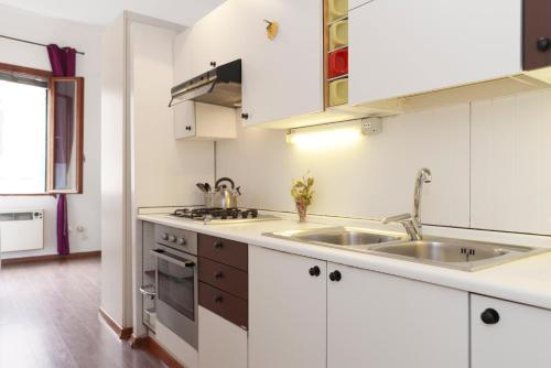 a kitchen with white cabinets and a sink at San Severo in Venice