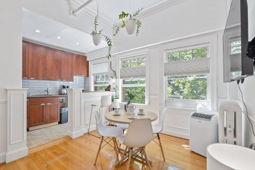 a kitchen with white walls and a table and chairs at Zen Gem Studio Downtown in Seattle