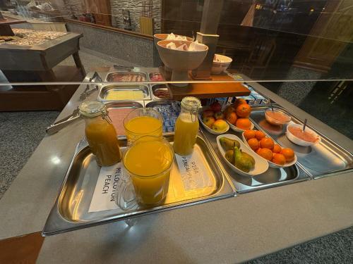 a tray of juice and drinks on a table at Hotel Los Olmos in Lugo