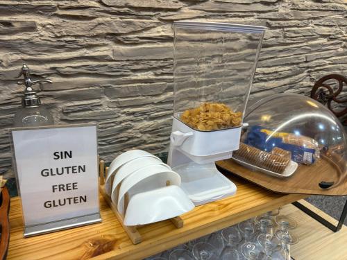 a food processor sitting on a table with food at Hotel Los Olmos in Lugo