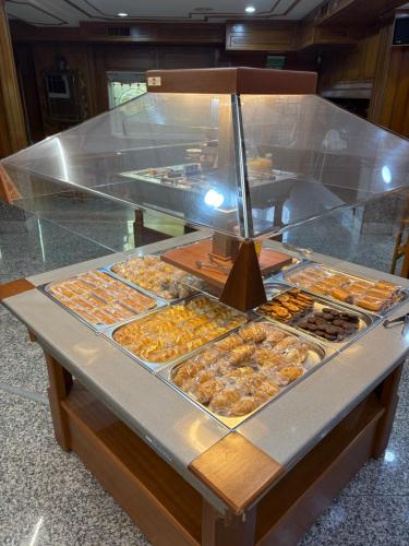 a display case with many different types of pastries at Hotel Los Olmos in Lugo