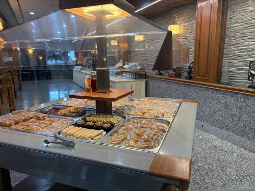 a buffet line with many different types of pastries at Hotel Los Olmos in Lugo