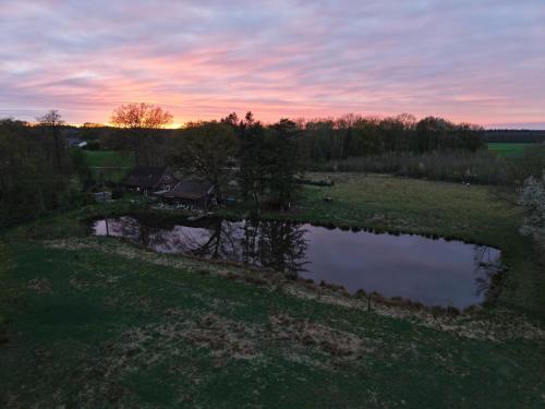 an aerial view of a pond in a field at Lotus Hütte in Eggermühlen