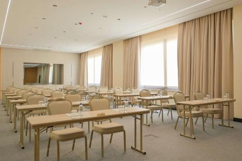 a conference room with tables and chairs and windows at Radisson Hotel Mersin in Mersin