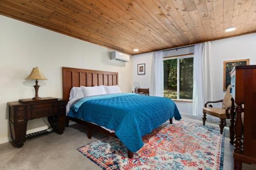 a bedroom with a bed and a wooden ceiling at Little Blue in Bellingham