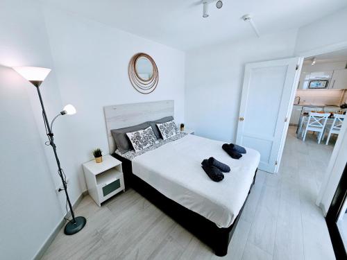a bedroom with a bed and a lamp and a table at OCEAN VIEW - renovation 2025 in Playa del Cura