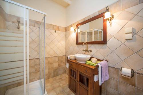 a bathroom with a sink and a shower at Villa Adonis by Villa Plus in Agnítsini