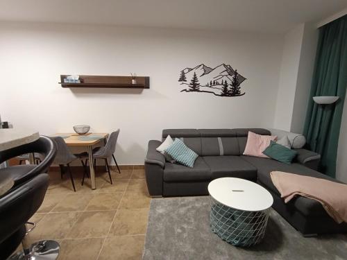 a living room with a couch and a table at Apartmán Frymburk in Frymburk