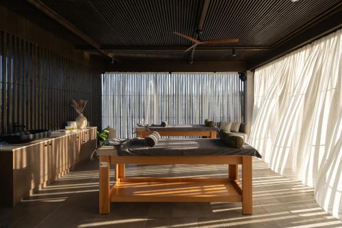 a room with a bed and a large window at The Ritual, A Wellness Retreat in Lampi
