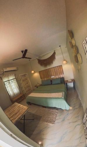 a bedroom with a bed and a ceiling at Point Break Varkala in Varkala