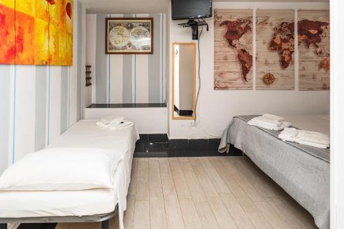 a room with two beds and a mirror at Affittacamere - L'ancora in Stintino