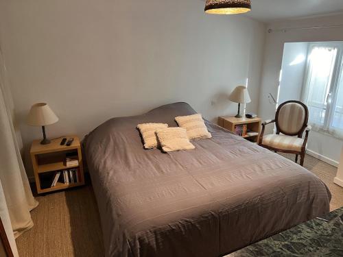 - une chambre dotée d'un lit avec deux oreillers et une chaise dans l'établissement Maison avec piscine 4 chambres 8 couchages, à Agris