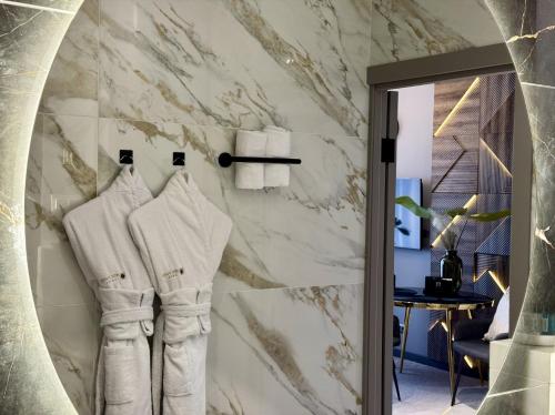 a bathroom with white towels hanging on a wall at HIDE PARK Hotel in Vinnytsya