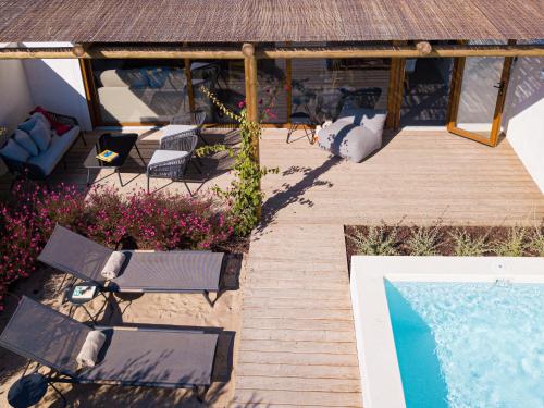 an overhead view of a patio with chairs and a swimming pool at Pestana Comporta Village Residences in Comporta