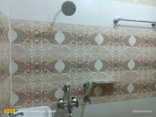 a bathroom with a shower curtain and a sink at Shri Ram Janam Homestay 300 Meter from Ram Mandir in Ayodhya