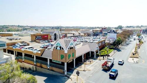 a city with a parking lot and a parking lot with cars at Oasis Home in Midrand